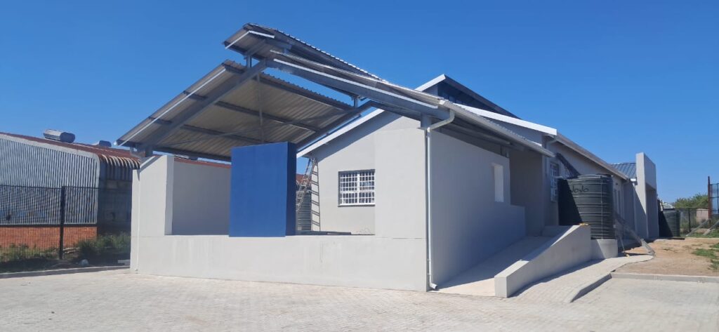 Completed small building project with blue roof and white walls